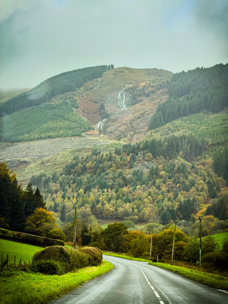 the winding road in the dinas mawddwy area makes the road itself the subject; this is not a claim of exploring the village.